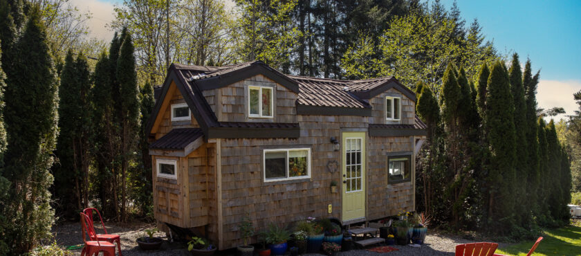 Cute little tiny home with wood paneling and privacy for a minimalist living experience