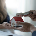 A professional female real estate agent receives a house loan payment or rent fee from her client