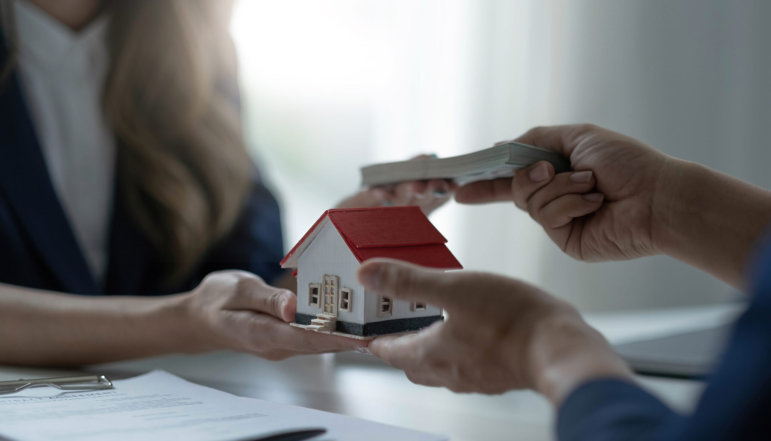 A professional female real estate agent receives a house loan payment or rent fee from her client