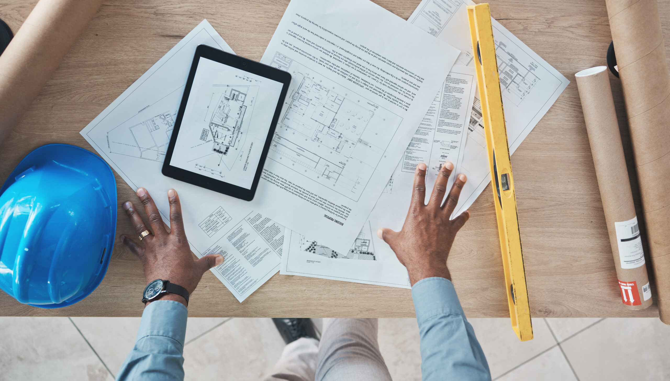 Architecture, person hands and blueprint planning, construction design and renovation on desk above