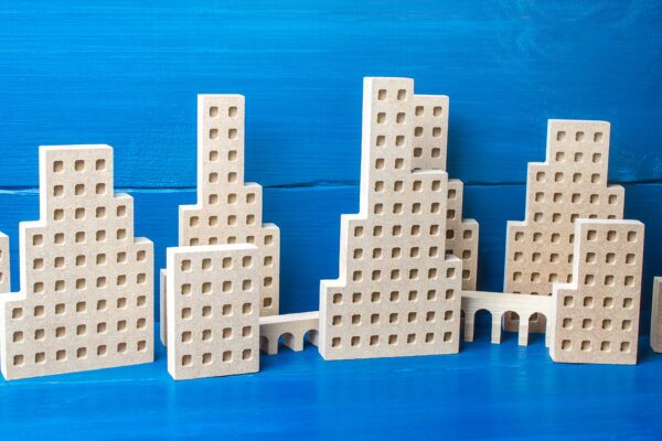 City of figures of buildings on a blue background. Concept for real estate